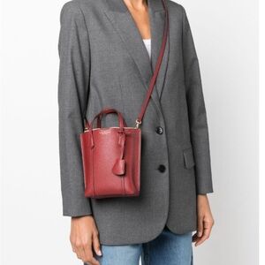 Tory Burch Mini Perry Leather Tote
Top carry handles
Gold-tone hardware